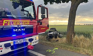 Der Saab prallte auf der Bundesstraße 252 gegen einen Baum und schleuderte dann ins Feld bevor er Feuer fing. - Feuerwehr Willebadessen Der Saab prallte auf der Bundesstraße 252 gegen einen Baum und schleuderte dann ins Feld bevor er Feuer fing. - Feuerwehr Willebadessen