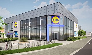 Die neue Lidl-Metropolfiliale am Stadtring: Im Erdgeschoss hinter der Glasfassade finden sich die Schleuse zur Parkgarage mit 86 Stellplätzen oder Rollstiege und Aufzug, mit der die Verkaufsfläche im Obergeschoss erreicht werden kann. - Tab-Architektur Die neue Lidl-Metropolfiliale am Stadtring: Im Erdgeschoss hinter der Glasfassade finden sich die Schleuse zur Parkgarage mit 86 Stellplätzen oder Rollstiege und Aufzug, mit der die Verkaufsfläche im Obergeschoss erreicht werden kann. - Tab-Architektur