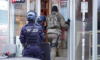 Ein Beamter versucht, Kontakt mit der Person aufzunehmen, die sich an der Mühlenstraße verschanzt hat. - Paul Brinkmann Ein Beamter versucht, Kontakt mit der Person aufzunehmen, die sich an der Mühlenstraße verschanzt hat. - Paul Brinkmann