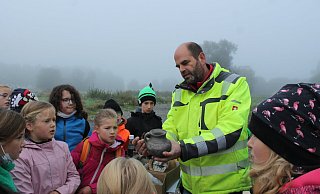 Dieser Fund vom Acker könnte ein Henkel gewesen sein – erklärt der Landesgartenschau-Archäologe Ralf Mahytka den Vierklässlern aus Ottbergen. - LGS 2023 Höxter/Manuela Puls Dieser Fund vom Acker könnte ein Henkel gewesen sein – erklärt der Landesgartenschau-Archäologe Ralf Mahytka den Vierklässlern aus Ottbergen. - LGS 2023 Höxter/Manuela Puls