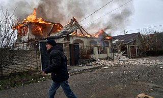 Ein Anwohner läuft an einem brennenden Haus in Cherson vorbei, das nach ukrainischen Angaben bei russischem Beschuss am orthodoxen Weihnachtsabend getroffen wurde. - Libkos/AP/dpa Ein Anwohner läuft an einem brennenden Haus in Cherson vorbei, das nach ukrainischen Angaben bei russischem Beschuss am orthodoxen Weihnachtsabend getroffen wurde. - Libkos/AP/dpa
