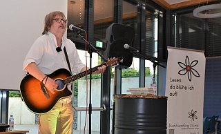 Der Bielefelder Straßenmusiker Stefan Just unterhält in der Mensa der Heinz-Sielmann-Schule seine Zuhörer mit seinen literarischen Ausflügen und seinen Songs zum Gitarrenspiel. - Karin Prignitz Der Bielefelder Straßenmusiker Stefan Just unterhält in der Mensa der Heinz-Sielmann-Schule seine Zuhörer mit seinen literarischen Ausflügen und seinen Songs zum Gitarrenspiel. - Karin Prignitz