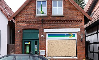 Die Fensterscheibe am Grünen-Bürgerbüro wurde zerstört und provisorisch mit einer Spanplatte abgedeckt. - Alex Lehn Die Fensterscheibe am Grünen-Bürgerbüro wurde zerstört und provisorisch mit einer Spanplatte abgedeckt. - Alex Lehn