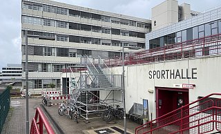Seit fast zwei Jahren ist der Eingang zum Sportbereich des Uni-Hauptgebäudes nur über diese behelfsmäßige Gerüsttreppe zu erreichen. - Peter Unger Seit fast zwei Jahren ist der Eingang zum Sportbereich des Uni-Hauptgebäudes nur über diese behelfsmäßige Gerüsttreppe zu erreichen. - Peter Unger