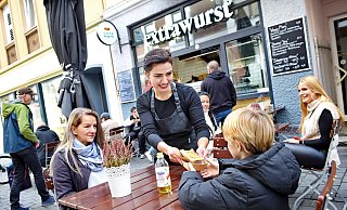 Imbiss-Chefin Aria Berkin serviert einem Gast die Extrawurst. - Barbara Franke Imbiss-Chefin Aria Berkin serviert einem Gast die Extrawurst. - Barbara Franke