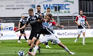 Arminia Bielefelds Sam Schreck stemmt sich im Zweikampf gegen den Kölner Luca Marseiler. - IMAGO/Beautiful Sports Arminia Bielefelds Sam Schreck stemmt sich im Zweikampf gegen den Kölner Luca Marseiler. - IMAGO/Beautiful Sports