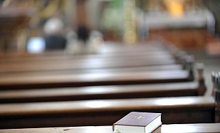 Ein Gesangbuch liegt verlassen in einer Kirchenbank. - Jens Schulze / epd Ein Gesangbuch liegt verlassen in einer Kirchenbank. - Jens Schulze / epd