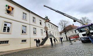 Mit schwerem Gerät werden die jecken Ehrenpräsidenten am Steinheimer Rathaus nach oben gehievt. - Madita Schellenberg Mit schwerem Gerät werden die jecken Ehrenpräsidenten am Steinheimer Rathaus nach oben gehievt. - Madita Schellenberg