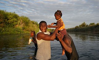 Auf der Flucht vor Armut und Konflikten in ihren Heimatländern kommen täglich Tausende Menschen in die USA - unter anderem über den Grenzfluss Rio Grande aus Mexiko. - Fernando Llano/AP/dpa Auf der Flucht vor Armut und Konflikten in ihren Heimatländern kommen täglich Tausende Menschen in die USA - unter anderem über den Grenzfluss Rio Grande aus Mexiko. - Fernando Llano/AP/dpa