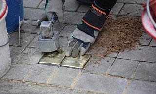 Künstler Gunter Demnig klopft in der Dr.-Neuhäußer-Strasse die beiden Stolpersteine fest, die an die Schwestern Emma und Berta Vorreuter erinnern sollen. - Elke Niedringhaus-Haasper Künstler Gunter Demnig klopft in der Dr.-Neuhäußer-Strasse die beiden Stolpersteine fest, die an die Schwestern Emma und Berta Vorreuter erinnern sollen. - Elke Niedringhaus-Haasper