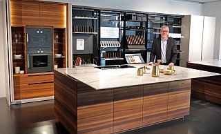 Werkstatt: Eggersmann-Geschäftsführer Michael Wunram hat die Küche in den Arbeitsmodus gebracht. Die Arbeitsplatte ist vom Ceranfeld geschoben, der Vitrinenschrank mit den Backöfen ist geöffnet und in den drehbaren Regalwände ist das Werkzeug des ambitionierten Kochs griffbereit. - Frank-Michael Kiel-Steinkamp Werkstatt: Eggersmann-Geschäftsführer Michael Wunram hat die Küche in den Arbeitsmodus gebracht. Die Arbeitsplatte ist vom Ceranfeld geschoben, der Vitrinenschrank mit den Backöfen ist geöffnet und in den drehbaren Regalwände ist das Werkzeug des ambitionierten Kochs griffbereit. - Frank-Michael Kiel-Steinkamp