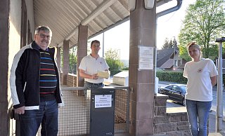 Helmut Springer (v. l.), Michael Weinreich und Vanessa Freitag freuen sich über die gespendeten Masken, die in die schwarze Box am Vereinsgebäude (Am Bahnhof 7) abgegeben werden können. - Helga Krooß Helmut Springer (v. l.), Michael Weinreich und Vanessa Freitag freuen sich über die gespendeten Masken, die in die schwarze Box am Vereinsgebäude (Am Bahnhof 7) abgegeben werden können. - Helga Krooß