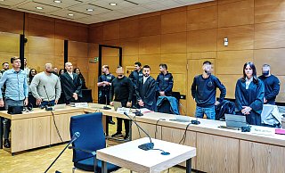 Die vier Angeklagten sollen gegenüber ihrem Opfer angegeben haben, zu den Bandidos zu gehören. Zum Prozessauftakt stehen sie im Gerichtssaal mit ihren Anwälten sowie einem Dolmetscher (ganz links). - Barbara Franke Die vier Angeklagten sollen gegenüber ihrem Opfer angegeben haben, zu den Bandidos zu gehören. Zum Prozessauftakt stehen sie im Gerichtssaal mit ihren Anwälten sowie einem Dolmetscher (ganz links). - Barbara Franke