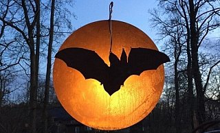 Eine Fledermaus bei Vollmond, geschaffen von Hans Kordes aus Kaunitz, soll in den alten Bäumen am Wall schweben. - Huxarium Eine Fledermaus bei Vollmond, geschaffen von Hans Kordes aus Kaunitz, soll in den alten Bäumen am Wall schweben. - Huxarium